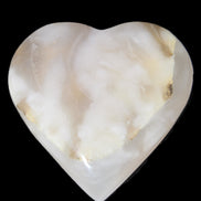 Mangano Calcite hand-carved heart 73*78*20mm 160g in sunlight - Rocks and Things Store