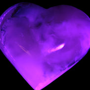 Mangano Calcite hand-carved heart 67mm  120/125g  in UV light - Rocks and Things Store