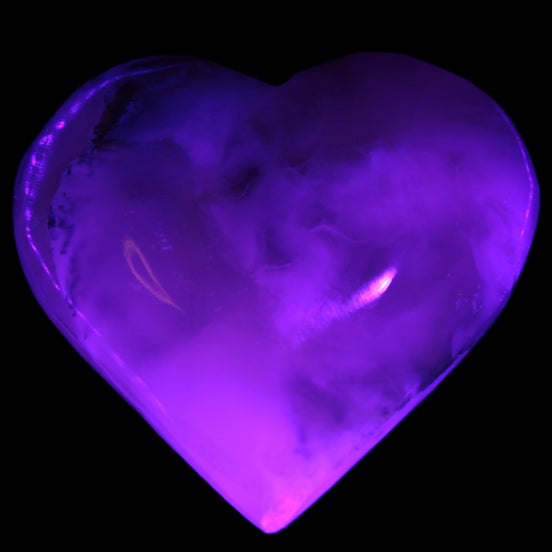 Mangano Calcite hand-carved heart 67mm  120/125g  in UV light - Rocks and Things Store
