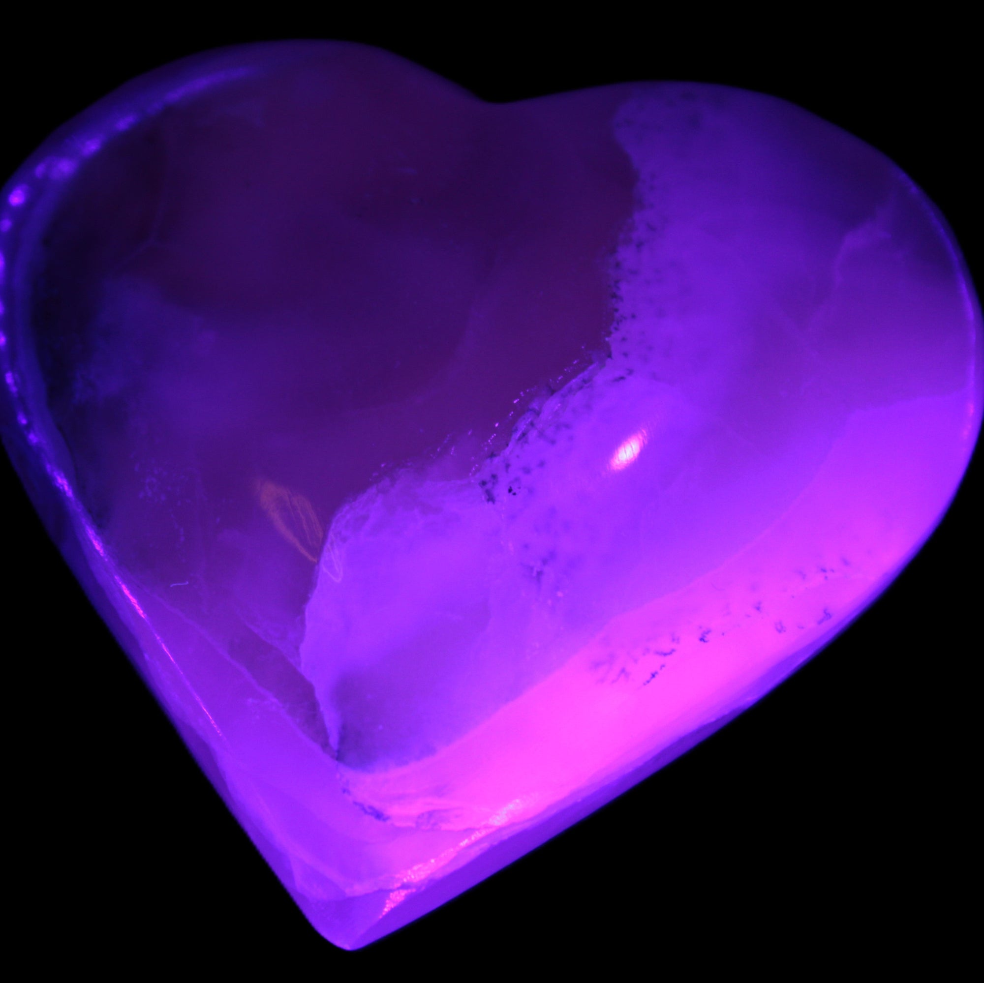 Mangano Calcite hand-carved heart 67mm  120/125g  in UV light - Rocks and Things Store