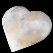 Mangano Calcite hand-carved heart 67mm  120/125g  in sunlight - Rocks and Things Store