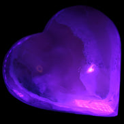 Mangano Calcite hand-carved heart 67mm 120/125g in UV light - Rocks and Things Store
