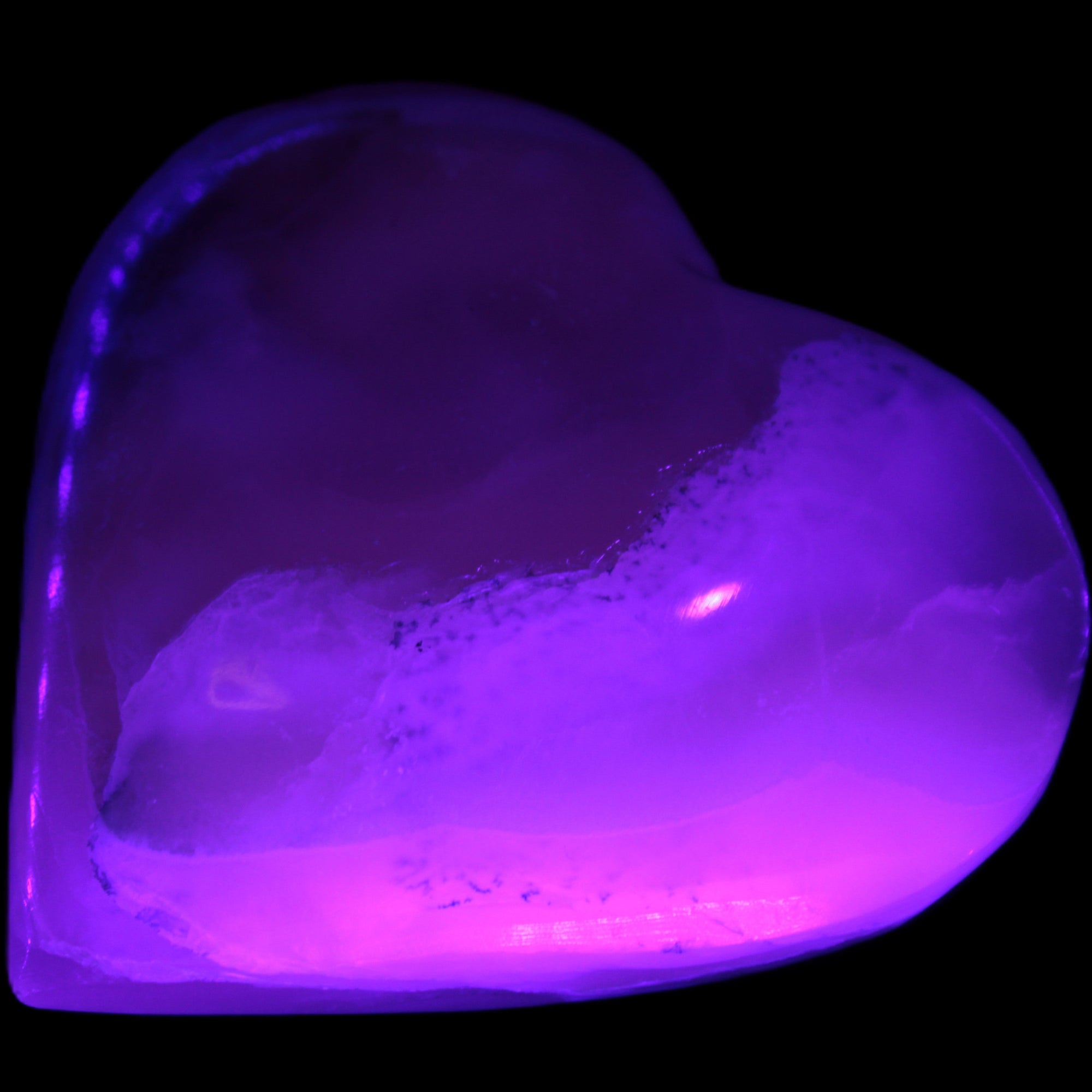 Mangano Calcite hand-carved heart 67mm 120/125g in UV light - Rocks and Things Store
