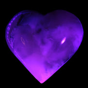 Mangano Calcite hand-carved heart 67mm 120/125g in UV light - Rocks and Things Store