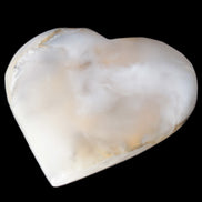 Mangano Calcite hand-carved heart 67mm 120/125g in sunlight - Rocks and Things Store