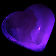 Mangano Calcite hand-carved heart 67mm 120/125g in UV light - Rocks and Things Store