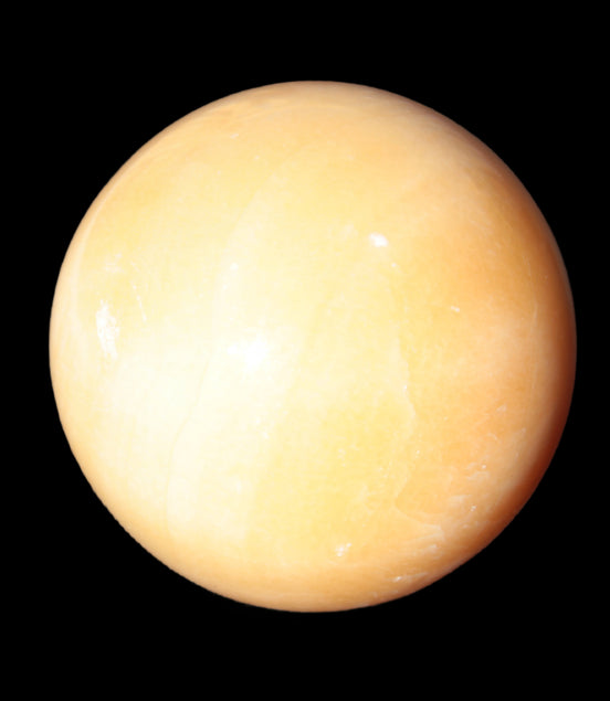 Honey Calcite sphere 53mm 187g in sunlight - Rocks and Things Store