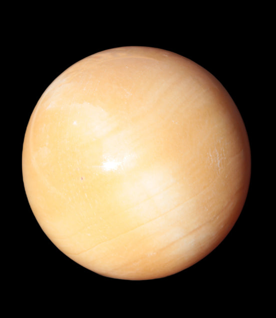 Honey Calcite sphere 53mm 187g in sunlight - Rocks and Things Store