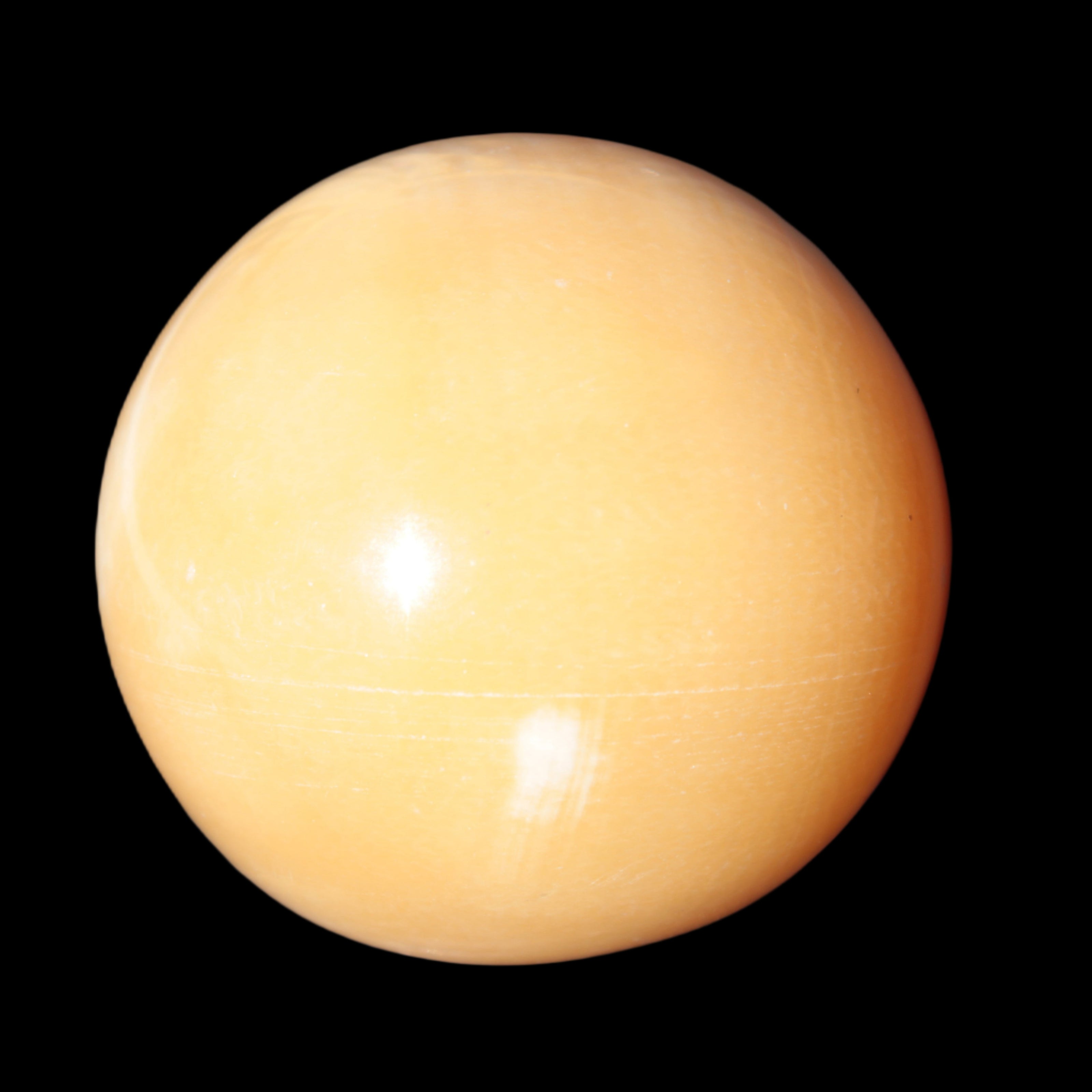 Honey Calcite sphere 53mm 187g in sunlight - Rocks and Things Store