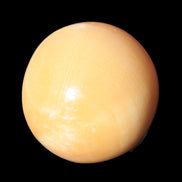 Honey Calcite sphere 53mm 187g in sunlight - Rocks and Things Store