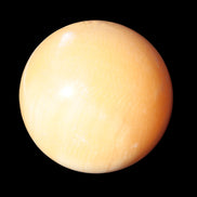 Honey Calcite sphere 53mm 187g in sunlight - Rocks and Things Store