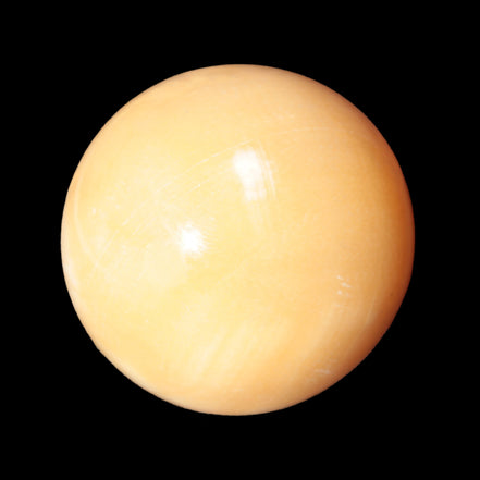 Honey Calcite sphere 53mm 187g in sunlight - Rocks and Things Store