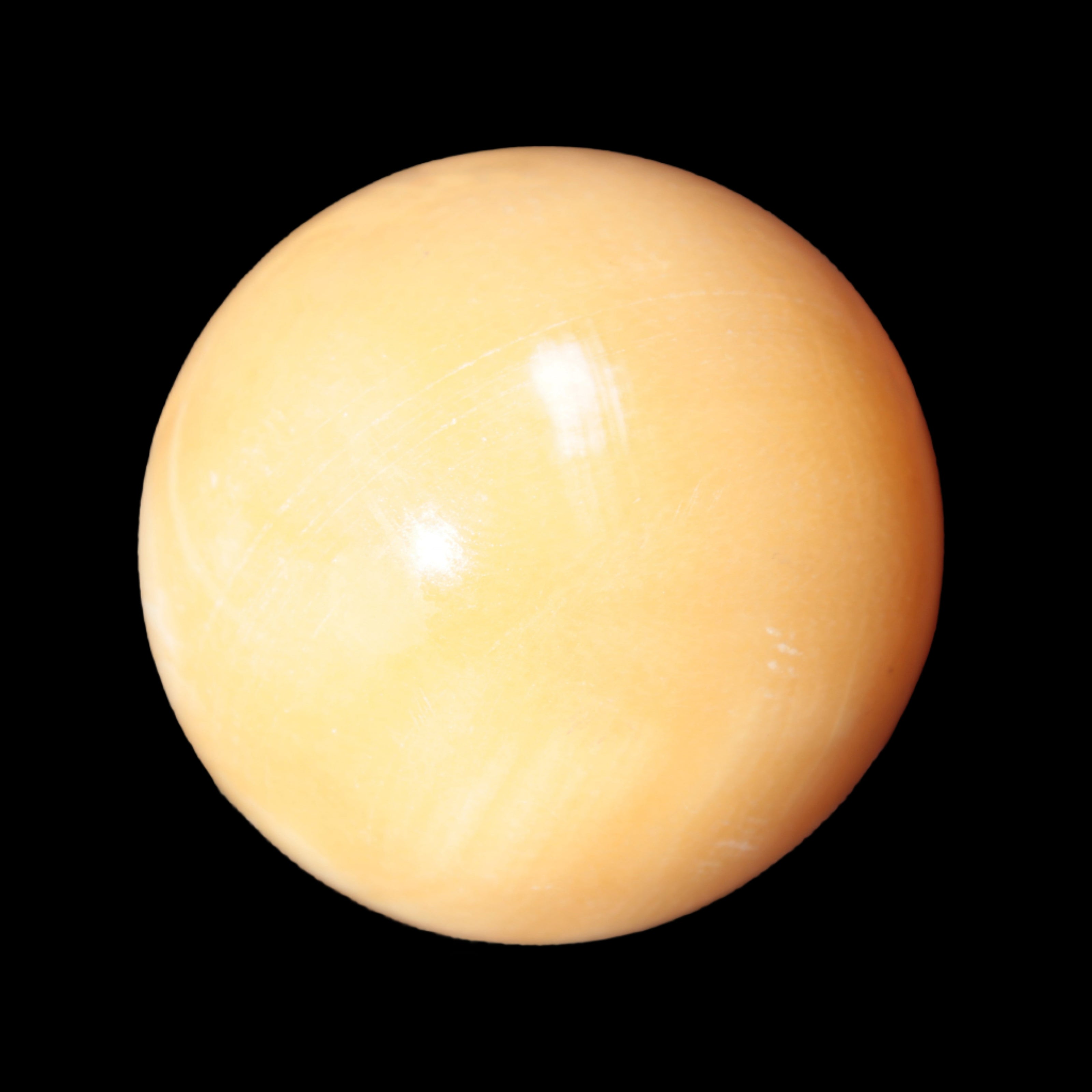Honey Calcite sphere 53mm 187g in sunlight - Rocks and Things Store