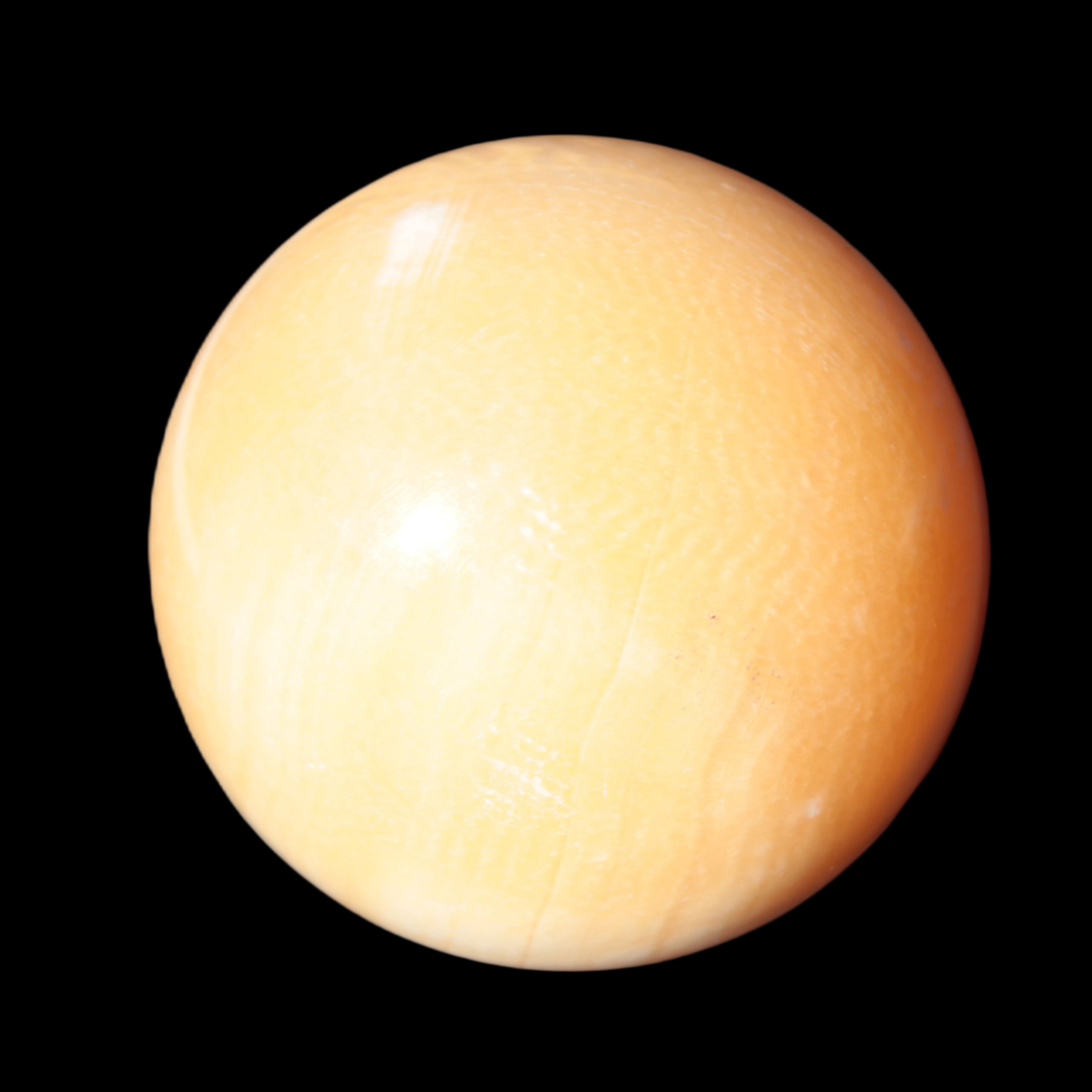 Honey Calcite sphere 53mm 187g in sunlight - Rocks and Things Store