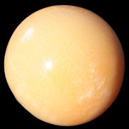 Honey Calcite sphere 53mm 187g in sunlight - Rocks and Things Store
