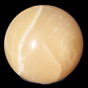 Topaz Honey Calcite sphere 63mm 341g in sunlight - Rocks and Things Store