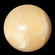 Topaz Honey Calcite sphere 63mm 341g in sunlight - Rocks and Things Store