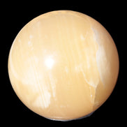 Topaz Honey Calcite sphere 63mm 341g in sunlight - Rocks and Things Store