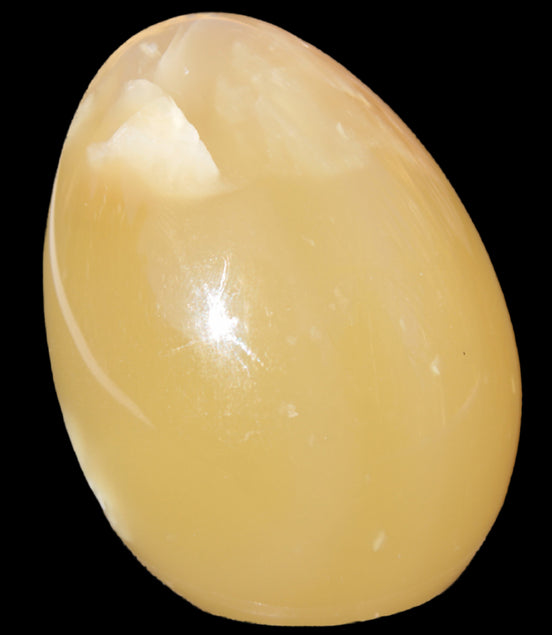 Honey Calcite Egg 47*72mm 252.4g in sunlight - Rocks and Things Store