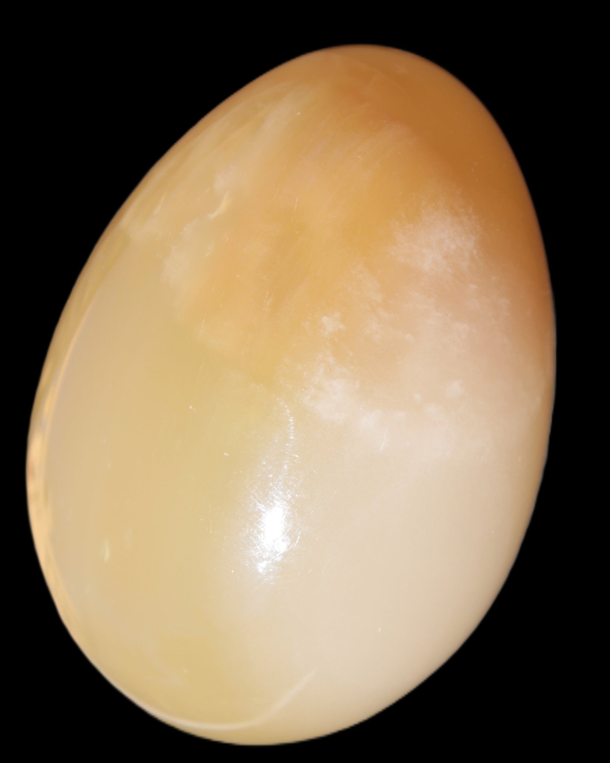 Honey Calcite Egg 47*72mm 252.4g in sunlight - Rocks and Things Store