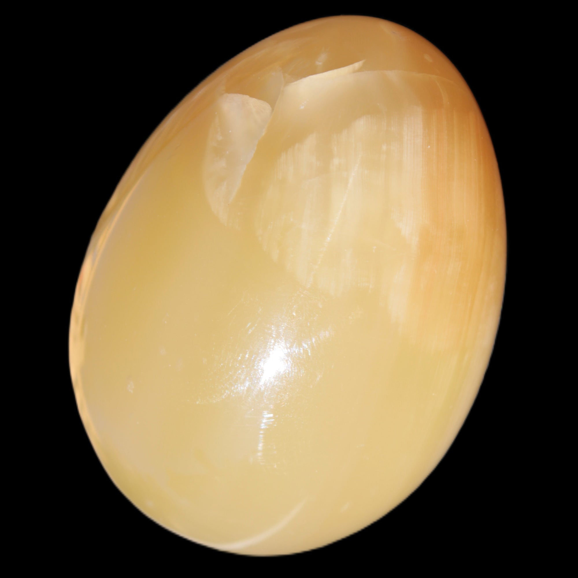 Honey Calcite Egg 47*72mm 252.4g in sunlight - Rocks and Things Store