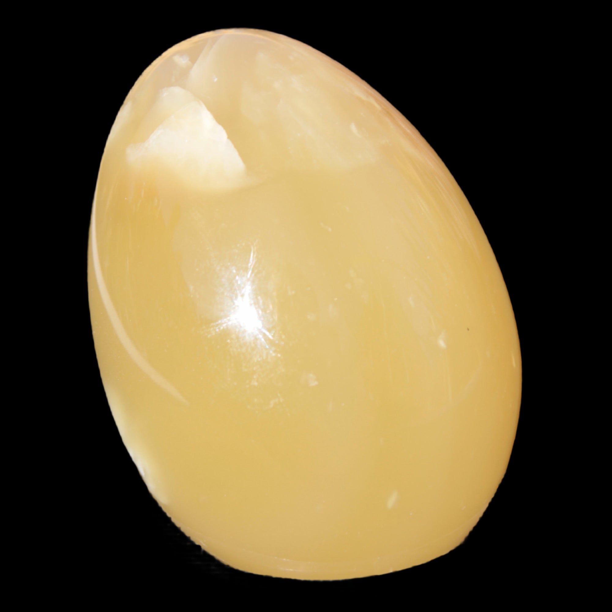 Honey Calcite Egg 47*72mm 252.4g in sunlight - Rocks and Things Store
