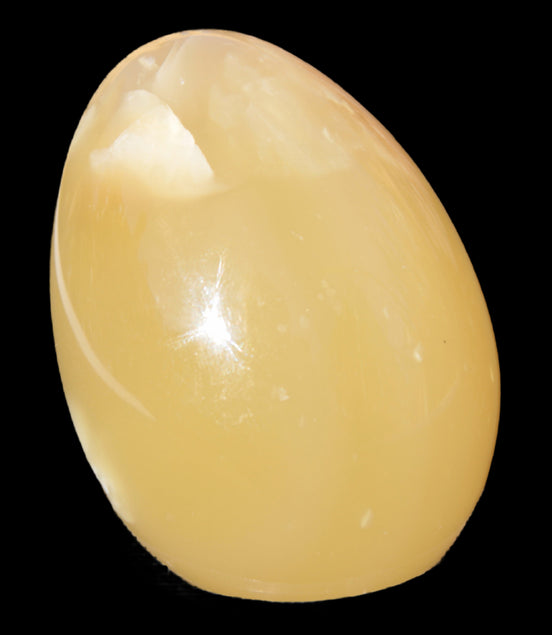 Honey Calcite Egg 47*72mm 252.4g in sunlight - Rocks and Things Store