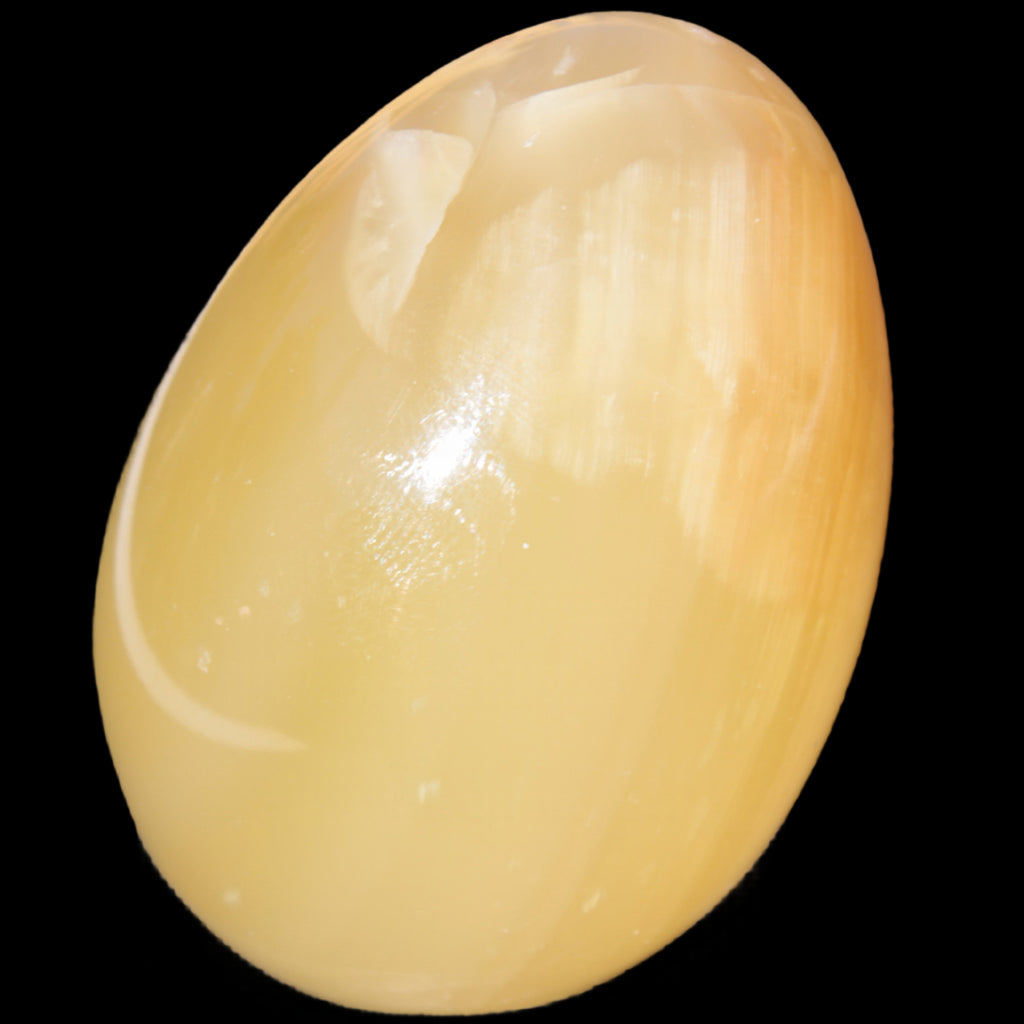 Honey Calcite Egg 47*72mm 252.4g in sunlight - Rocks and Things Store
