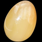 Honey Calcite Egg 47*72mm 252.4g in sunlight - Rocks and Things Store