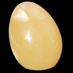 Honey Calcite Egg 47*72mm 252.4g in sunlight - Rocks and Things Store