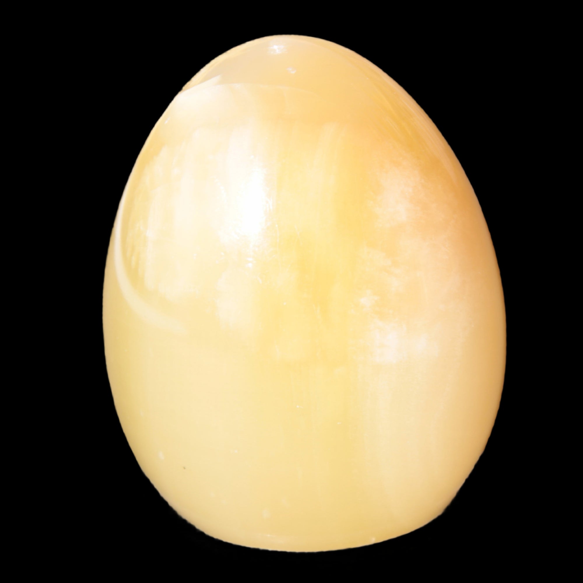 Honey Calcite Egg 47*72mm 252.4g in sunlight - Rocks and Things Store