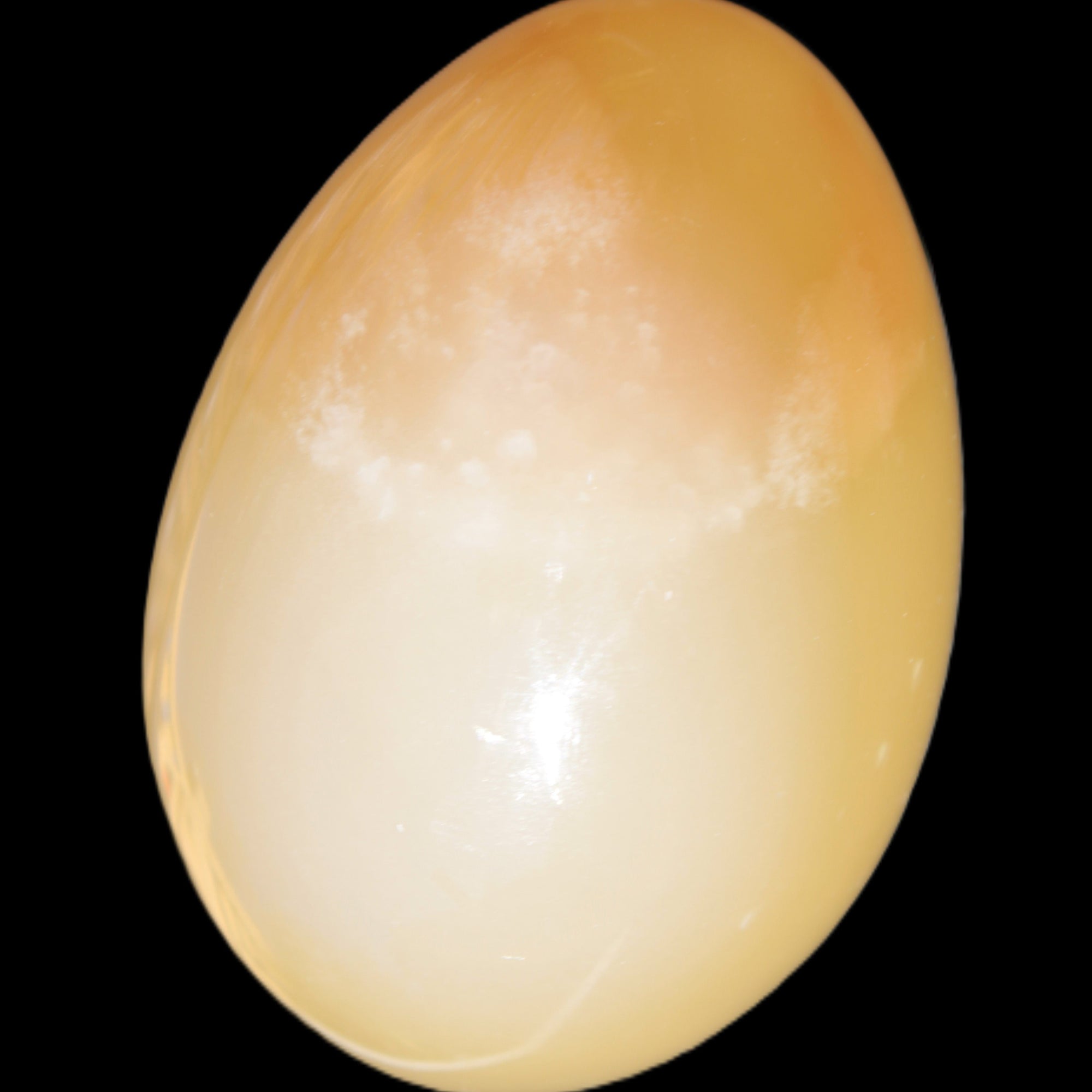 Honey Calcite Egg 47*72mm 252.4g in sunlight - Rocks and Things Store