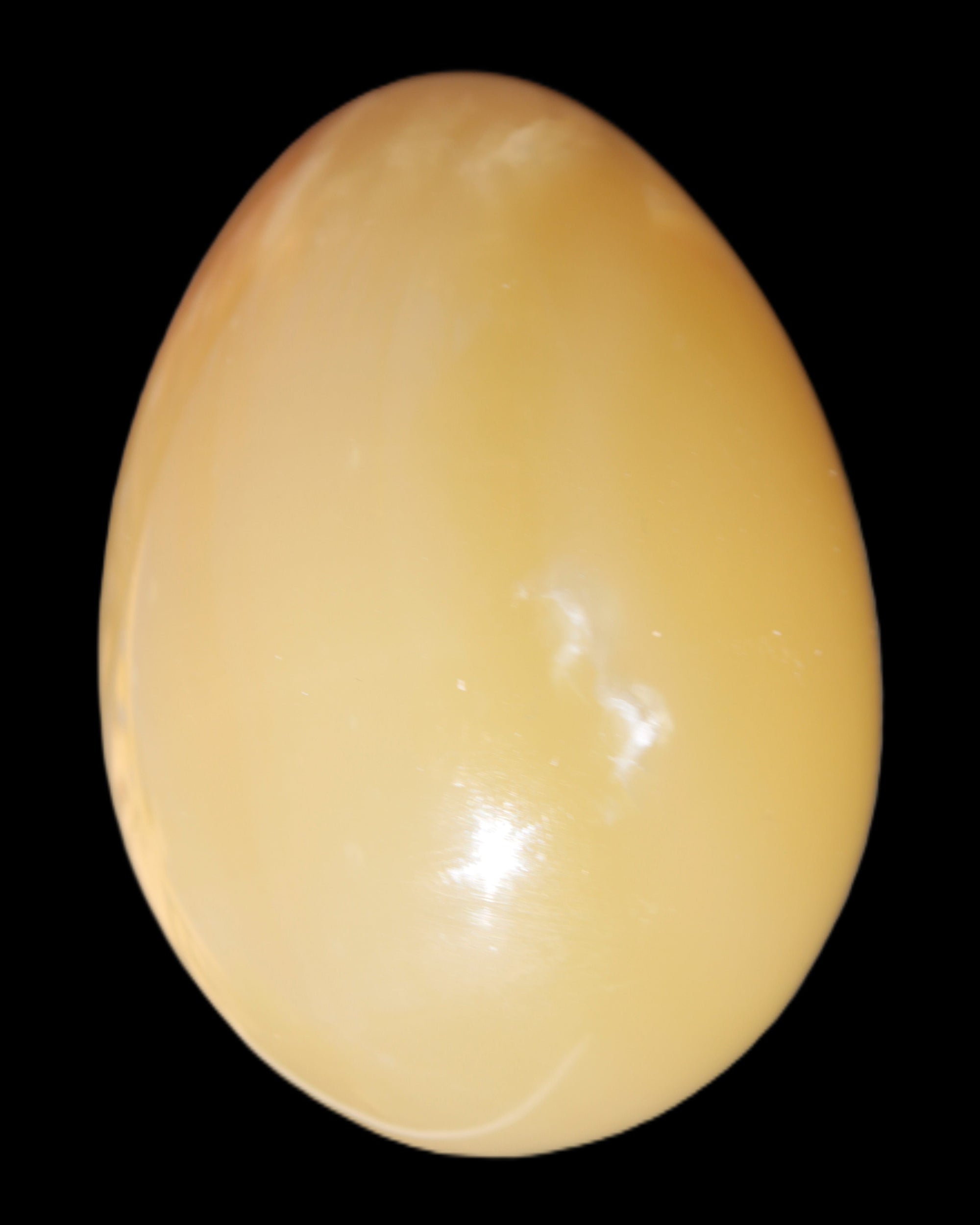 Honey Calcite Egg 47*72mm 252.4g in sunlight - Rocks and Things Store