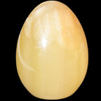 Honey Calcite Egg 47*72mm 252.4g in sunlight - Rocks and Things Store