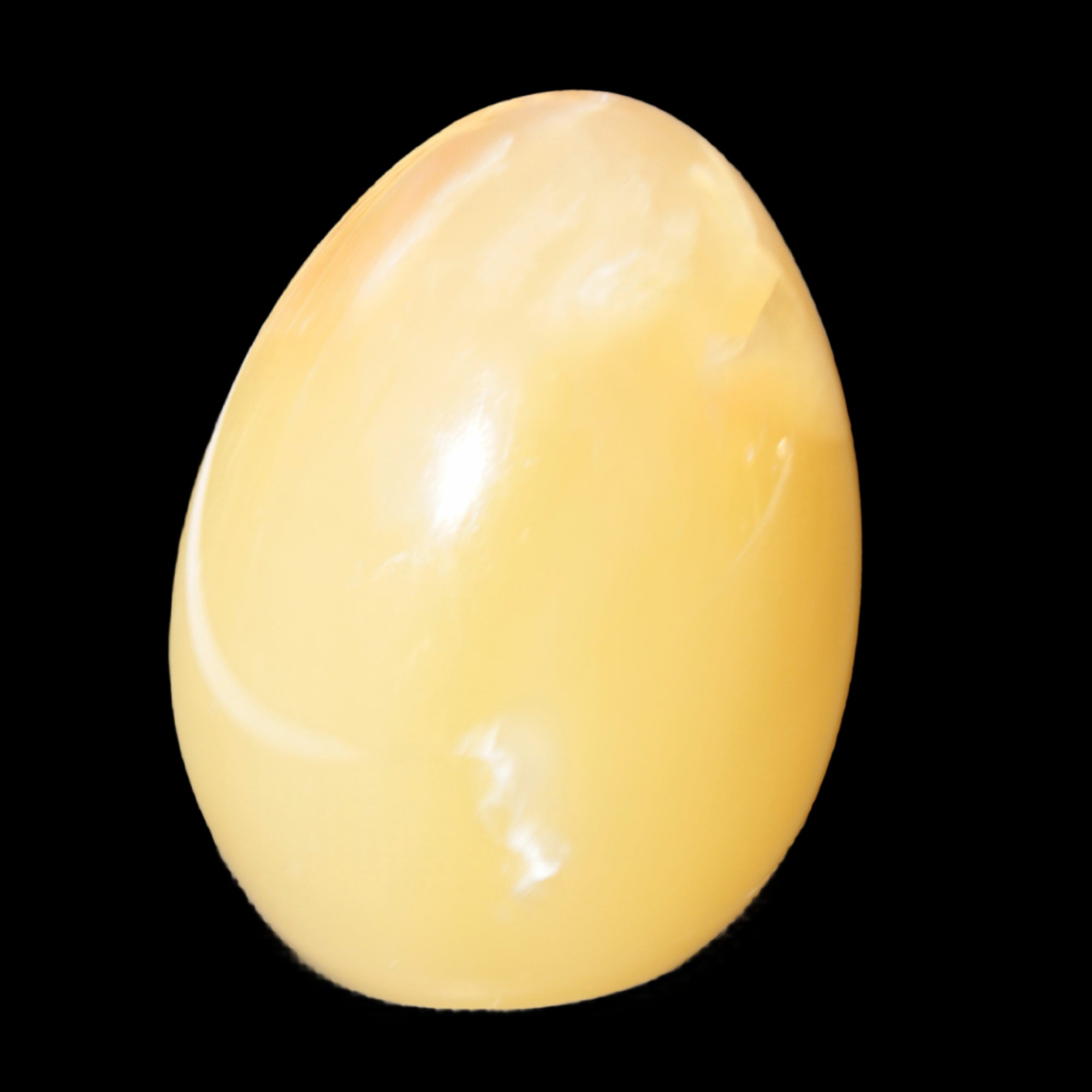 Honey Calcite Egg 47*72mm 252.4g in sunlight - Rocks and Things Store