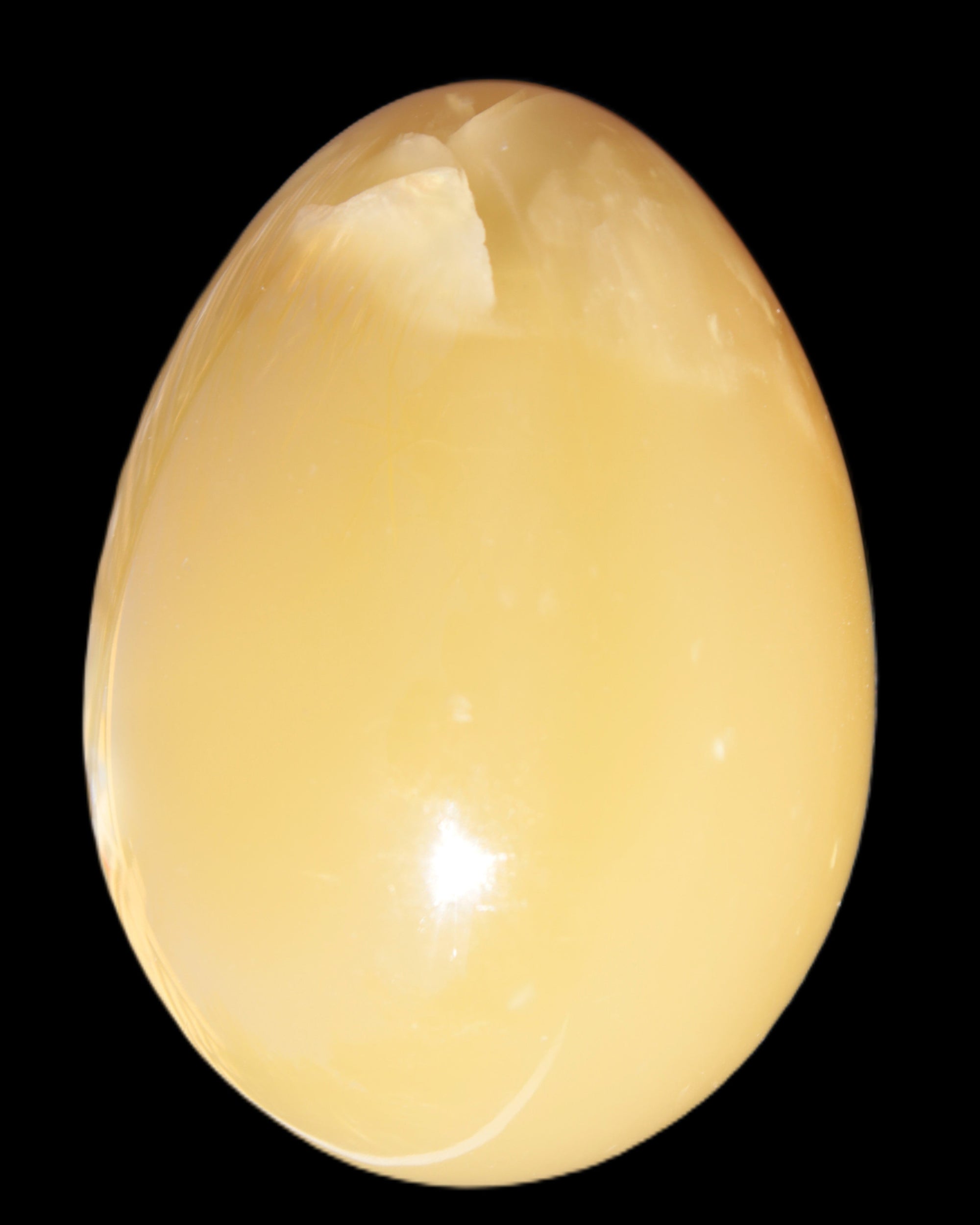 Honey Calcite Egg 47*72mm 252.4g in sunlight - Rocks and Things Store