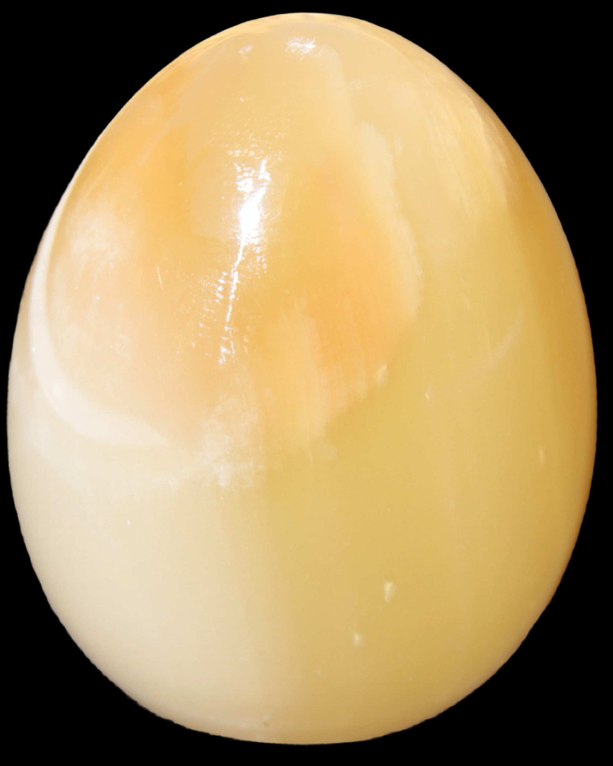 Honey Calcite Egg 47*72mm 252.4g in sunlight - Rocks and Things Store