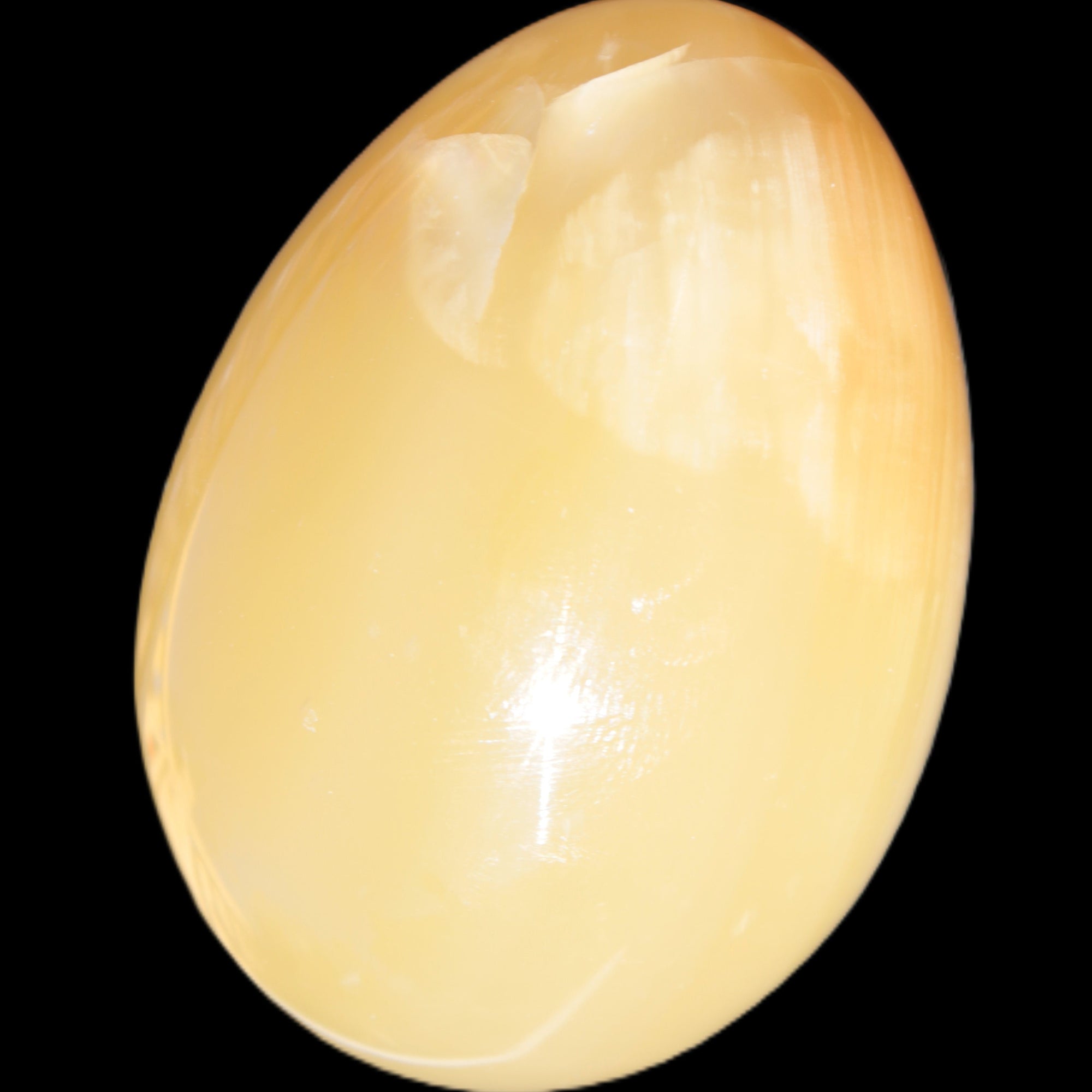Honey Calcite Egg 47*72mm 252.4g in sunlight - Rocks and Things Store