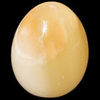 Honey Calcite Egg 47*72mm 252.4g in sunlight - Rocks and Things Store