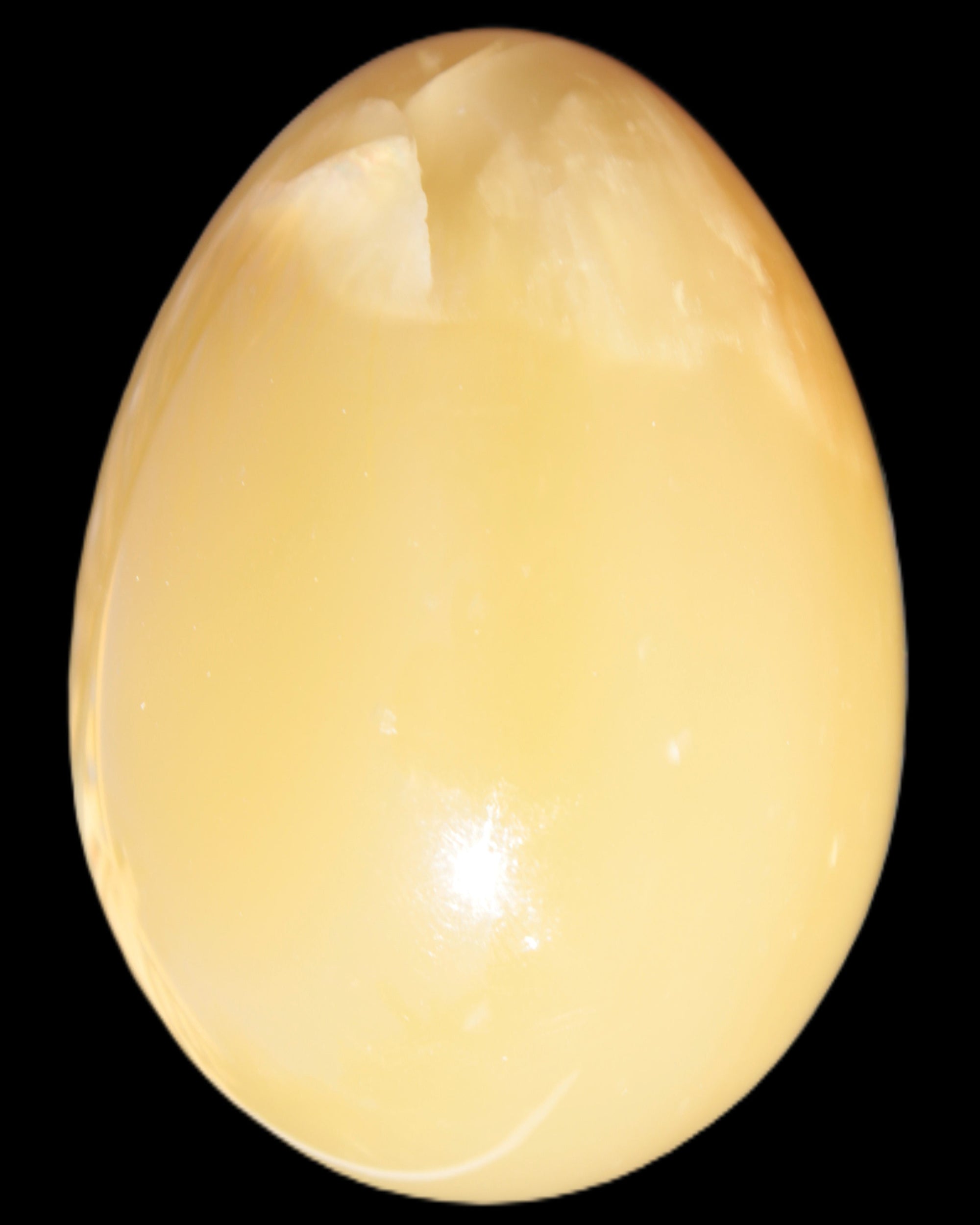 Honey Calcite Egg 47*72mm 252.4g in sunlight - Rocks and Things Store