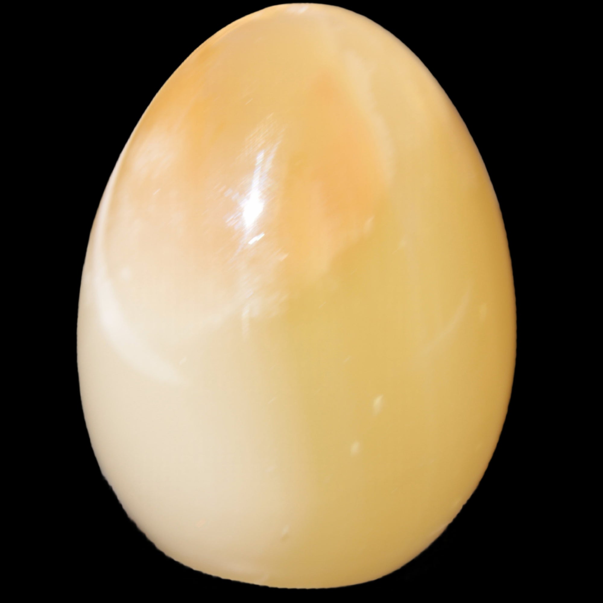 Honey Calcite Egg 47*72mm 252.4g in sunlight - Rocks and Things Store
