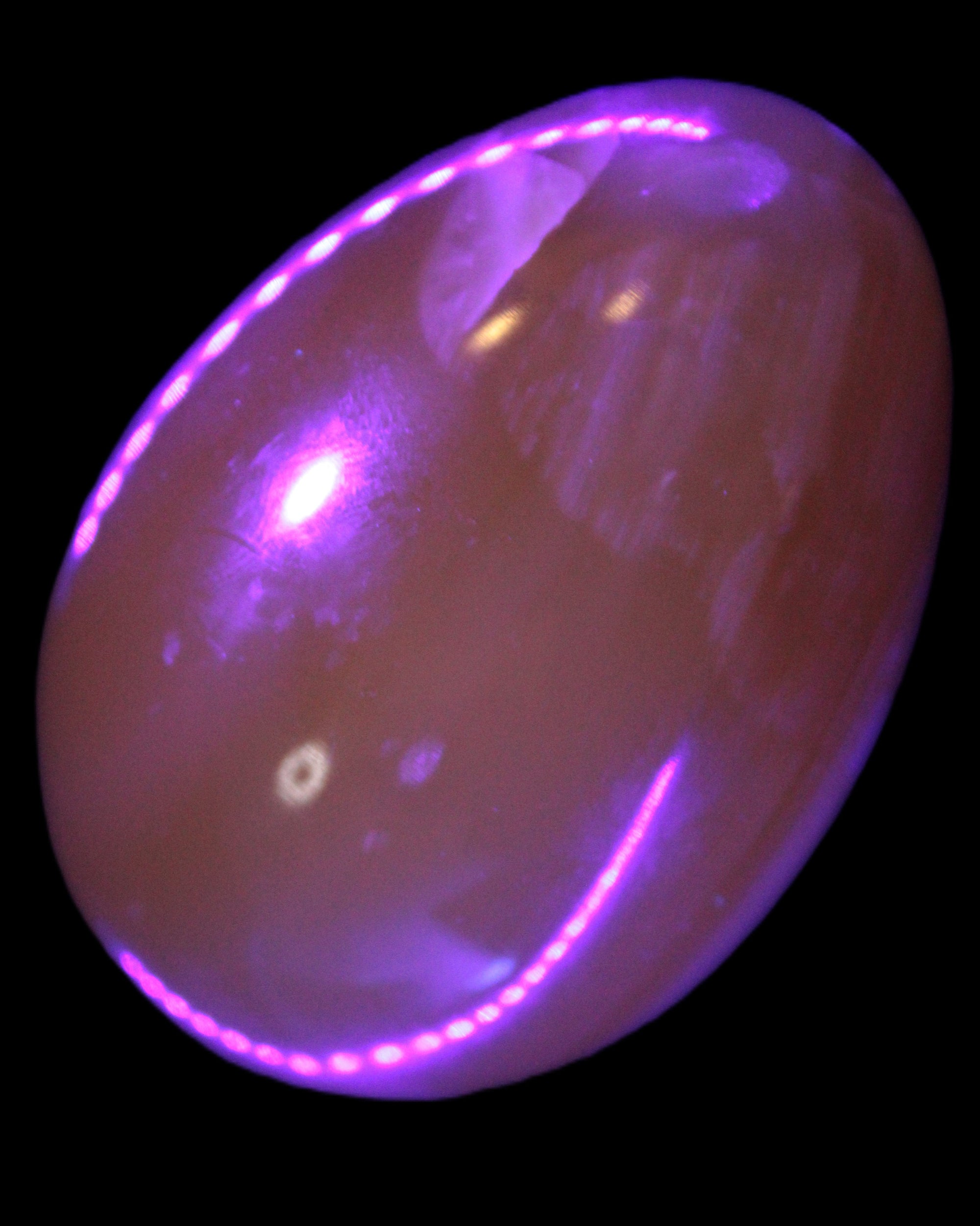 Honey Calcite Egg 47*72mm 252.4g in UV light - Rocks and Things Store