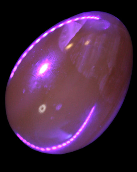 Honey Calcite Egg 47*72mm 252.4g in UV light - Rocks and Things Store