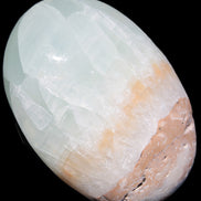 Pistachio Calcite palmstone 64-72mm  121-168g in sunshine - Rocks and Things Store