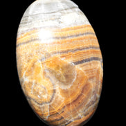 BumbleBee Calcite palm stone 64-70mm 108-130g in sunlight - Rocks and Things Store