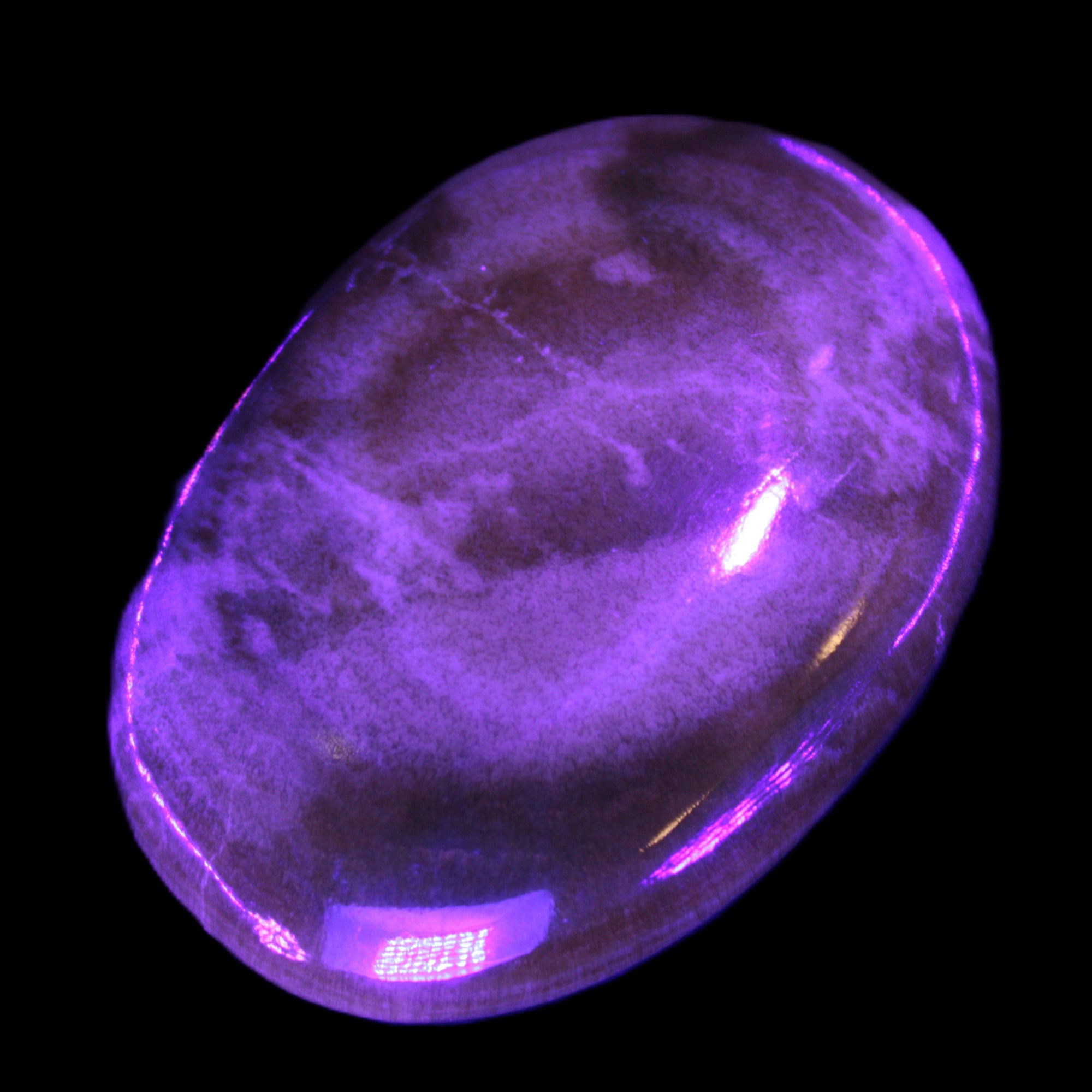 BumbleBee Calcite palm stone 64-70mm 108-130g in UV light - Rocks and Things Store
