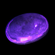 BumbleBee Calcite palm stone 64-70mm 108-130g in UV light - Rocks and Things Store