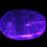Pink Sorbet Calcite palm stone in UV light