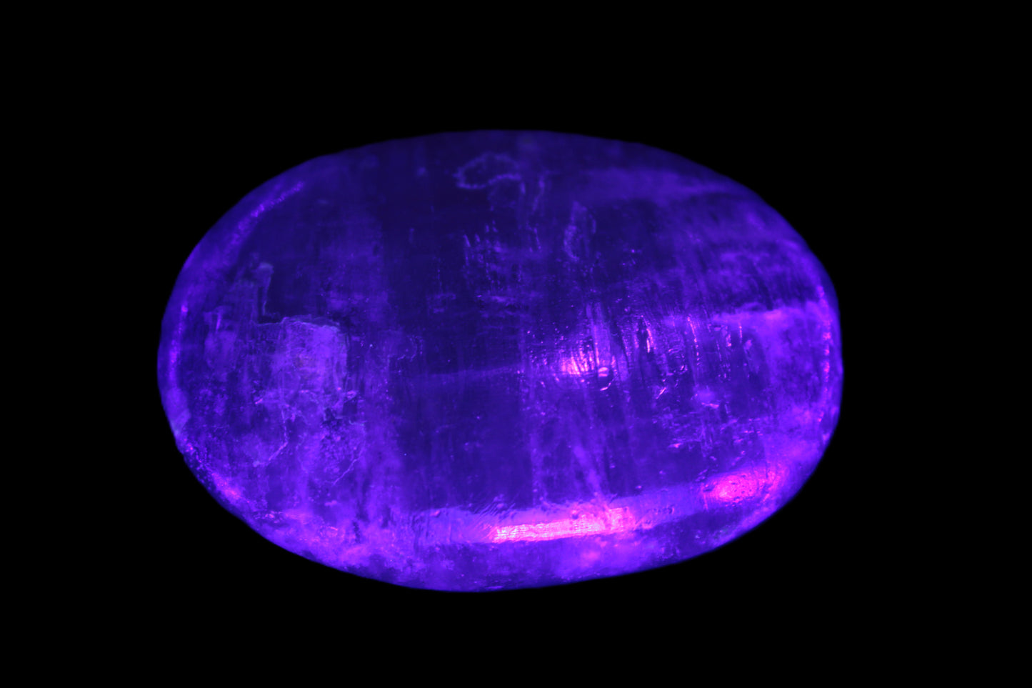 Pink Sorbet Calcite palm stone in UV light