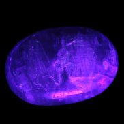 Pink Sorbet Calcite palm stone in UV light